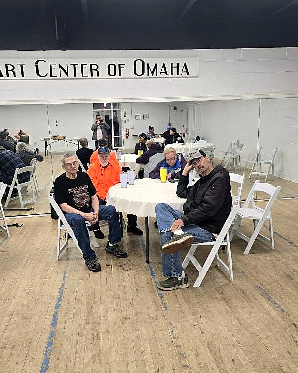 Residents gathered around a table at a community outing