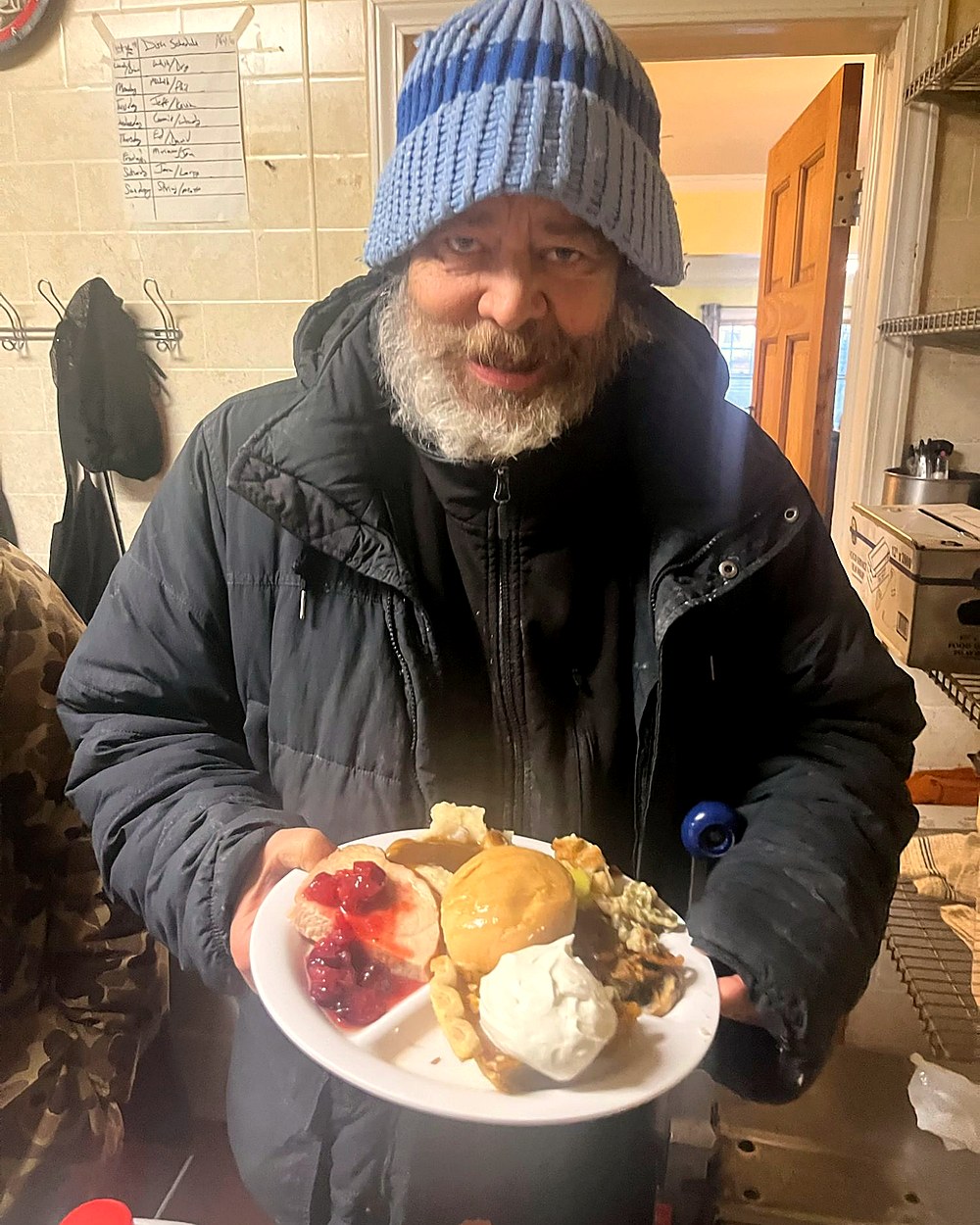Resident smiling with a full holiday dinner plate