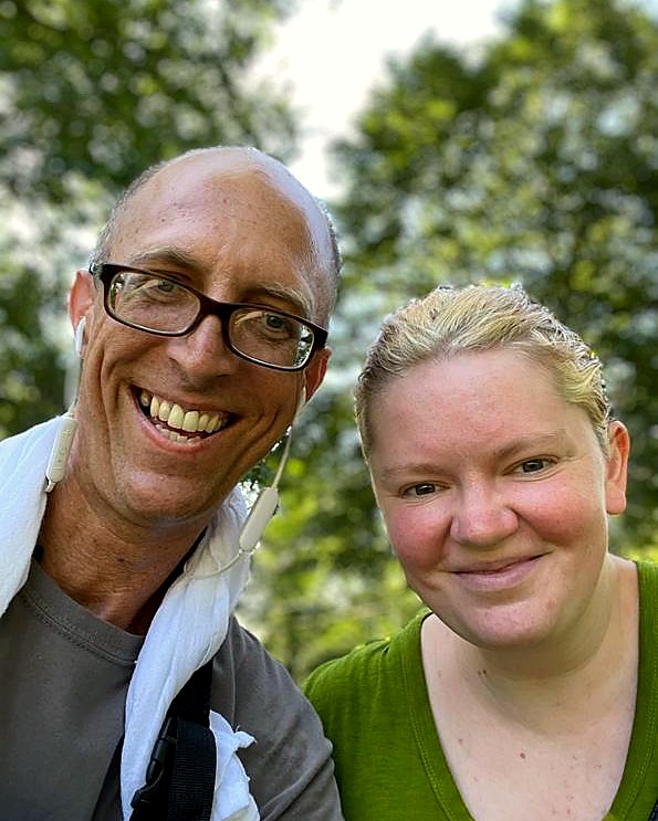 Two friends smiling outdoors on a walk