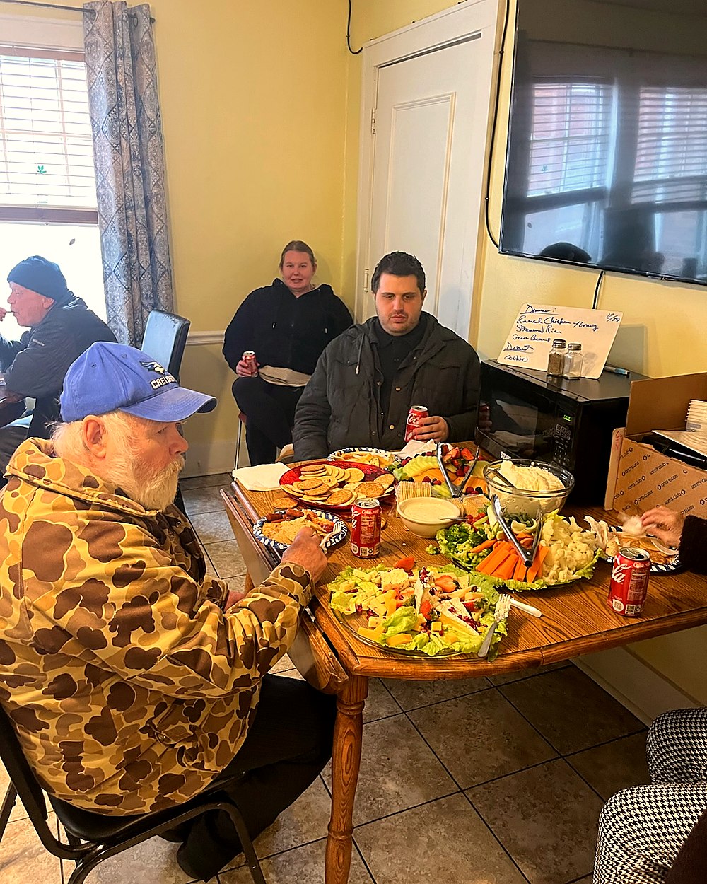 Residents enjoying a chef-prepared meal together at the dining table